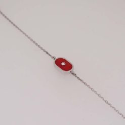 Bracelet ovale en or blanc, corail rouge et diamant.